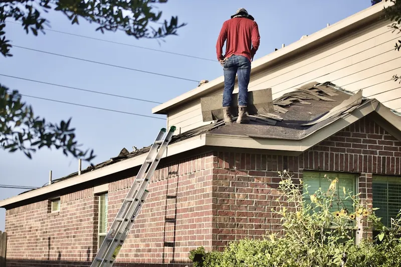 Professional roofer working on a residential roof in Orland Hills